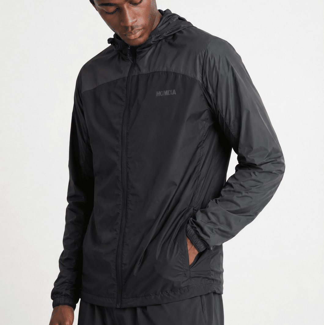 Homixa Shield Block men's windbreaker jacket in black and graphite, lightweight and wind-resistant outdoor apparel.