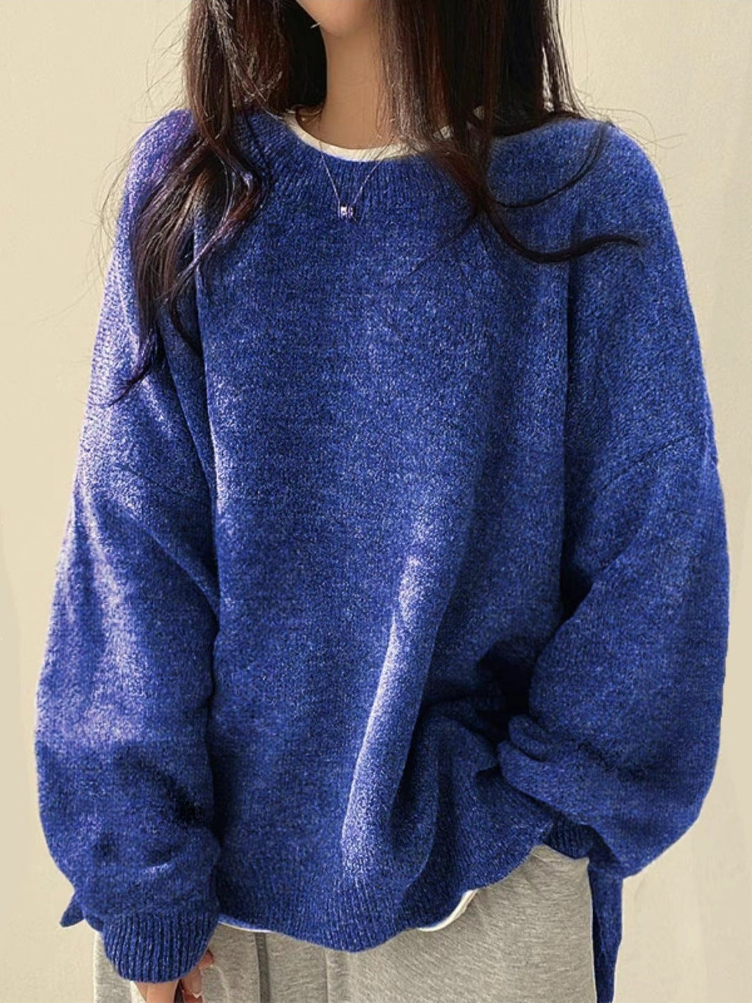 Homixa BILOG oversized knit sweater with crew neck, long sleeves, ribbed cuffs, and solid color finish, displayed on a model.