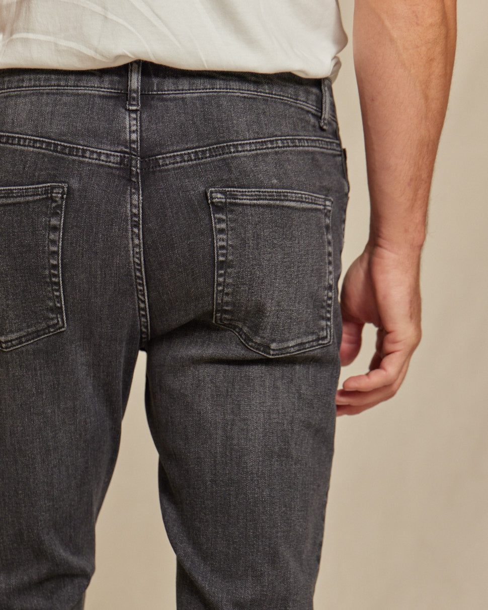 Men's stretch denim jeans by Olive & Evy with a durable fit and 4-way performance, shown in a classic blue color.