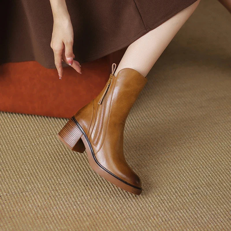 Homixa women's ankle boots with a relaxed fit, featuring stylish design and stitching details on smooth leather surface.
