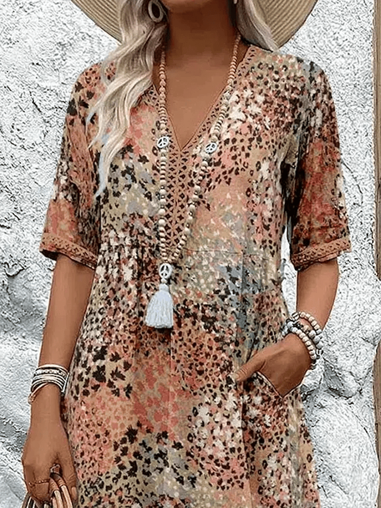 Homixa Sienna women's printed midi dress showing a flowy, colorful floral pattern and knee-length design on a model.