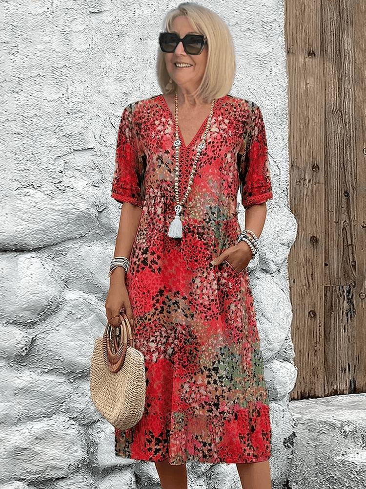 Homixa Sienna women's printed midi dress displayed on a hanger, showcasing vibrant floral patterns and flowing fabric.