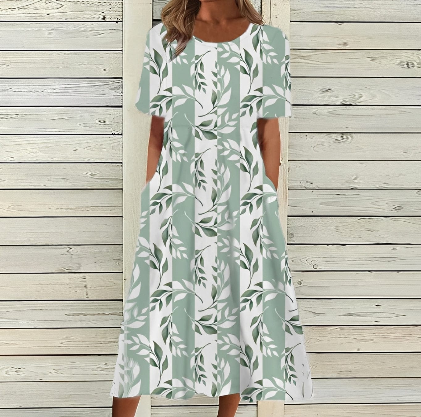 Elegant women's midi dress by Mainz-Mode featuring a floral pattern and flowing silhouette for a sophisticated look.