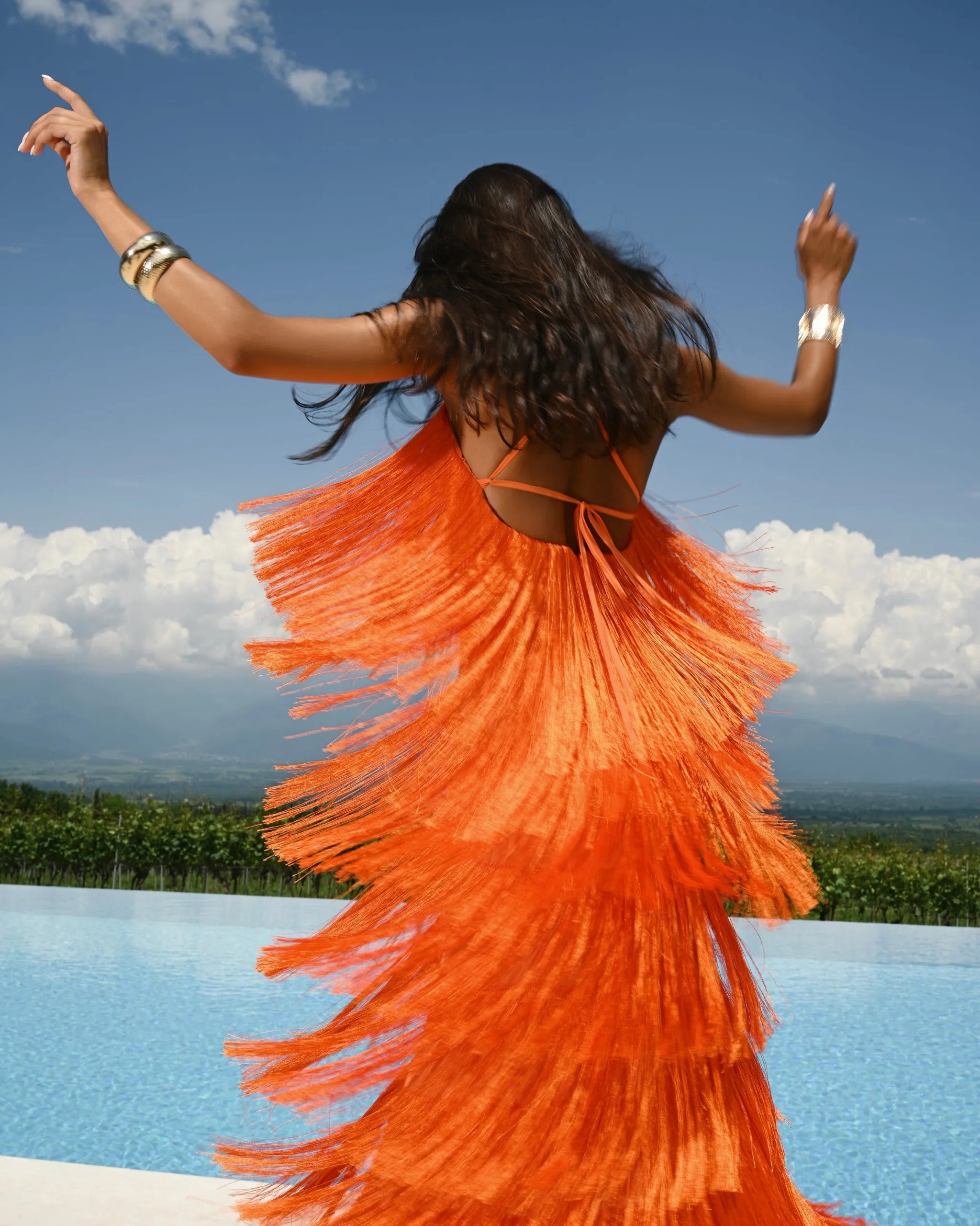 Homixa women's tiered fringe spaghetti-strap maxi dress with flowing layers and boho style, showcased on a model.