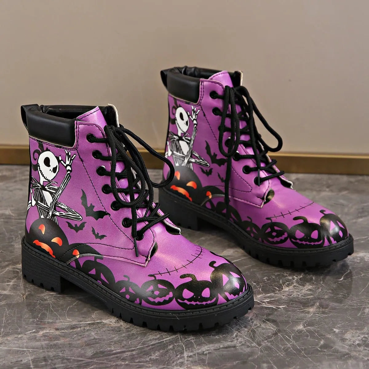 Women's Halloween combat boots by Homixa featuring skeleton, pumpkin, and bat lace-up design for festive spooky style.