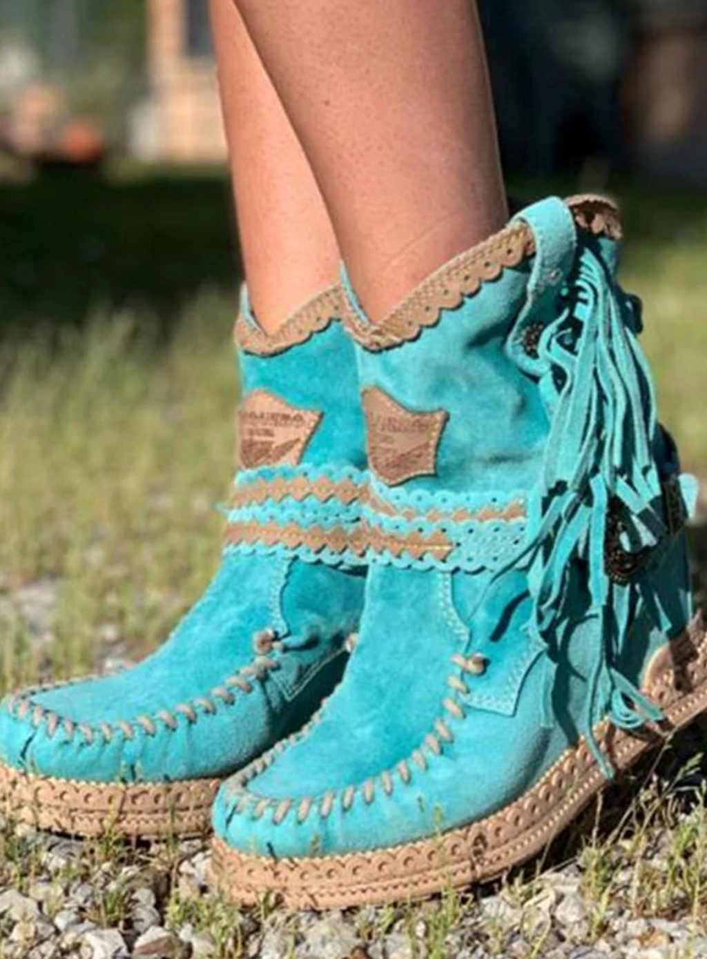 Women's boho Western boots by Homixa featuring fringe, buckle accents, and decorative stitching on stylish ankle booties.