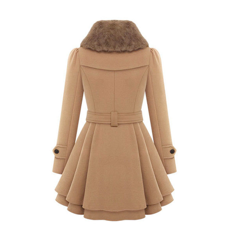 A woman wearing the Claudia vintage flair trench coat by Avery Lane Brighton, stylish women's coat with classic design and belt detail.
