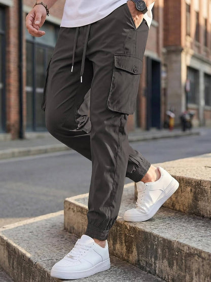 Homixa Belvora men's cargo joggers with drawstring waist, flap pockets, tapered cuffs, casual streetwear style.