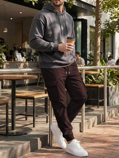 Homixa Belvora men's cargo joggers with drawstring waist, flap pockets, and tapered cuffs, shown in a relaxed fit style.