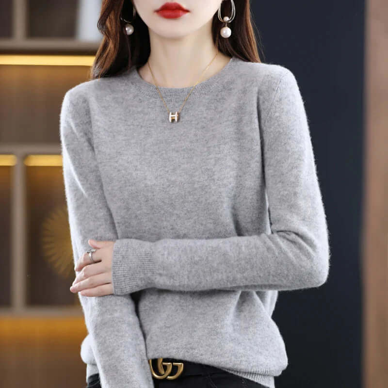 Homixa Belvia women's fine-knit crew-neck sweater with ribbed cuffs and solid color finish, styled on a model.
