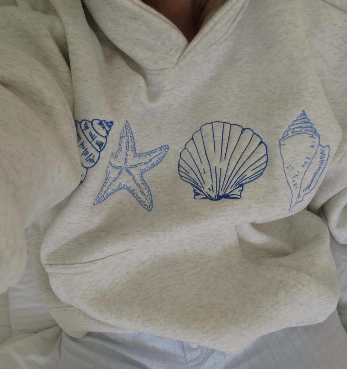 Women's seashell print hoodie by Lunirel featuring a soft fabric with a nautical seashell pattern and a cozy fit.