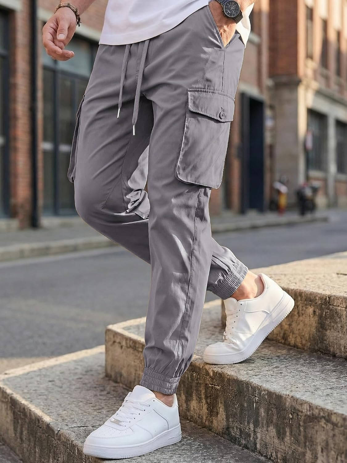 Homixa Belvora men's cargo joggers with drawstring waist, flap pockets, and tapered cuffs displayed on a model.