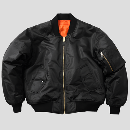 Black women’s unisex classic bomber jacket by Beckmiller, featuring a stylish, versatile design with a ribbed collar and cuffs.