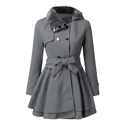 A woman wearing the Claudia vintage flair trench coat by Avery Lane Brighton, stylish women's coat with classic design and beige color.