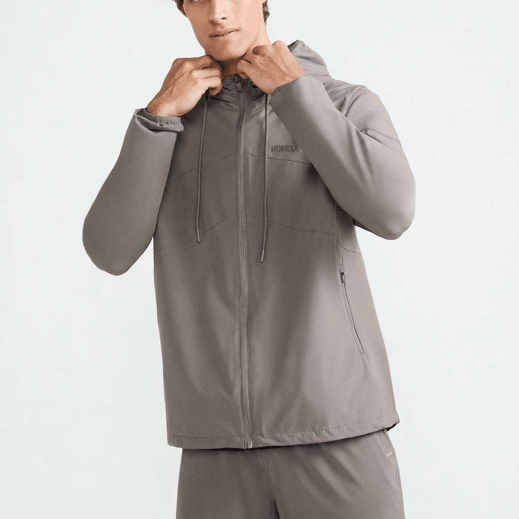 Homixa Active Shield men's windbreaker in khaki gray, lightweight jacket with a hood and zip closure for outdoor activities.