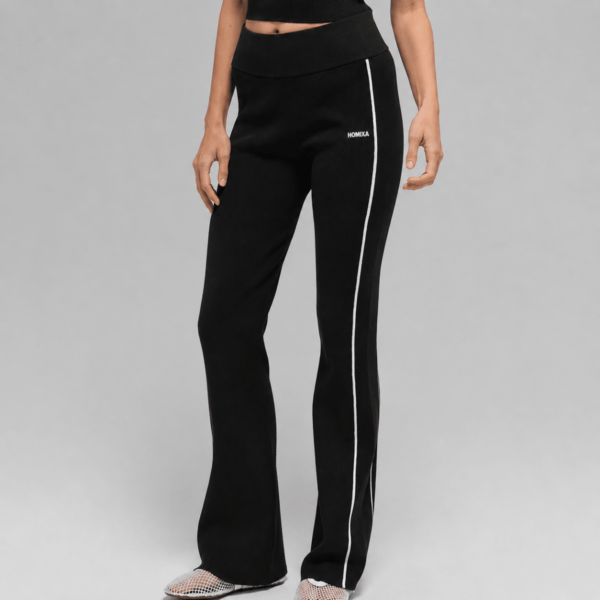 Black Homixa ribbed flare women's leggings with white stripe detail, stretchy fabric, and fitted design.