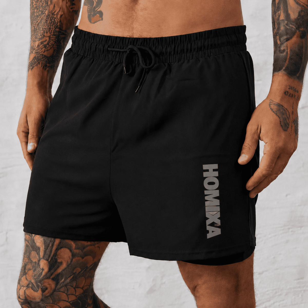 Homixa Core 2-in-1 men's black shorts set featuring a comfortable shorts and matching top, casual athletic style.