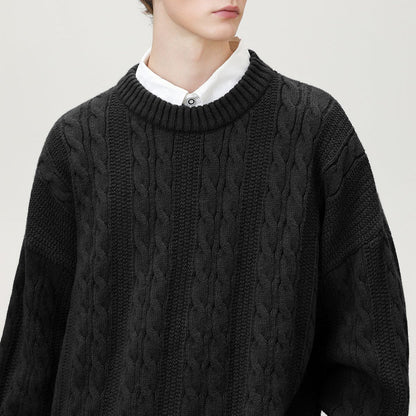 Homixa Arbury cable-knit crew-neck sweater with relaxed fit, dropped shoulders, and ribbed cuffs, shown on a model.