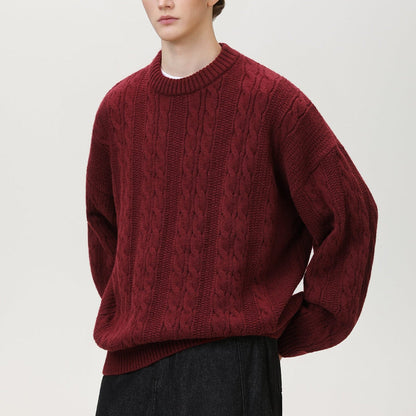Homixa Arbury cable-knit crew-neck sweater with relaxed fit, dropped shoulders, and ribbed cuffs, displayed on a model.