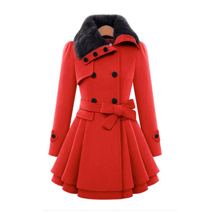 A woman wears the Claudia vintage flair trench coat by Avery Lane Brighton, showcasing its classic style and tailored fit.