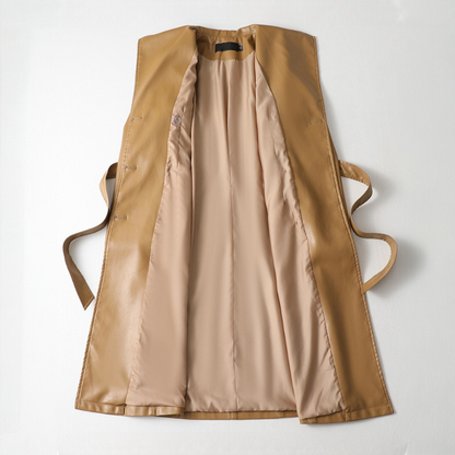 Jack Hafford Chelsea sheepskin leather trench coat hanging on a wooden rack with a classic design and luxurious texture.