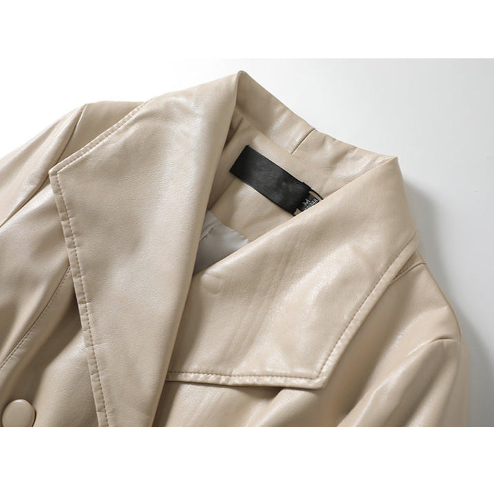Jack Hafford Chelsea sheepskin leather trench coat hanging on a clothing rack, showcasing its classic design and textured material.