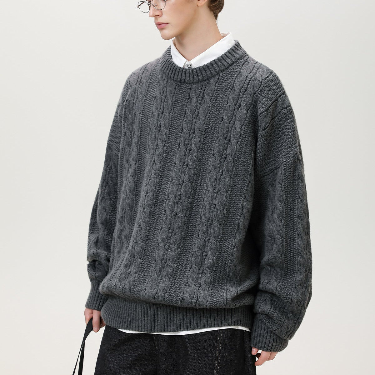 Homixa Arbury cable-knit crew-neck sweater with relaxed fit, dropped shoulders, and ribbed cuffs, styled on a model.