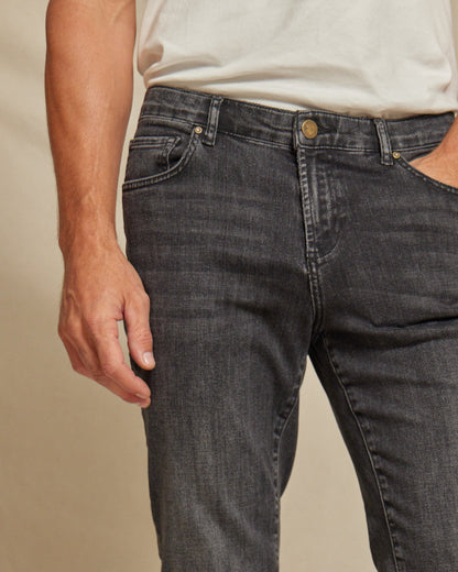 Men's stretch denim jeans by Olive & Evy featuring a durable fit and 4-way performance stretch, shown in a casual style.