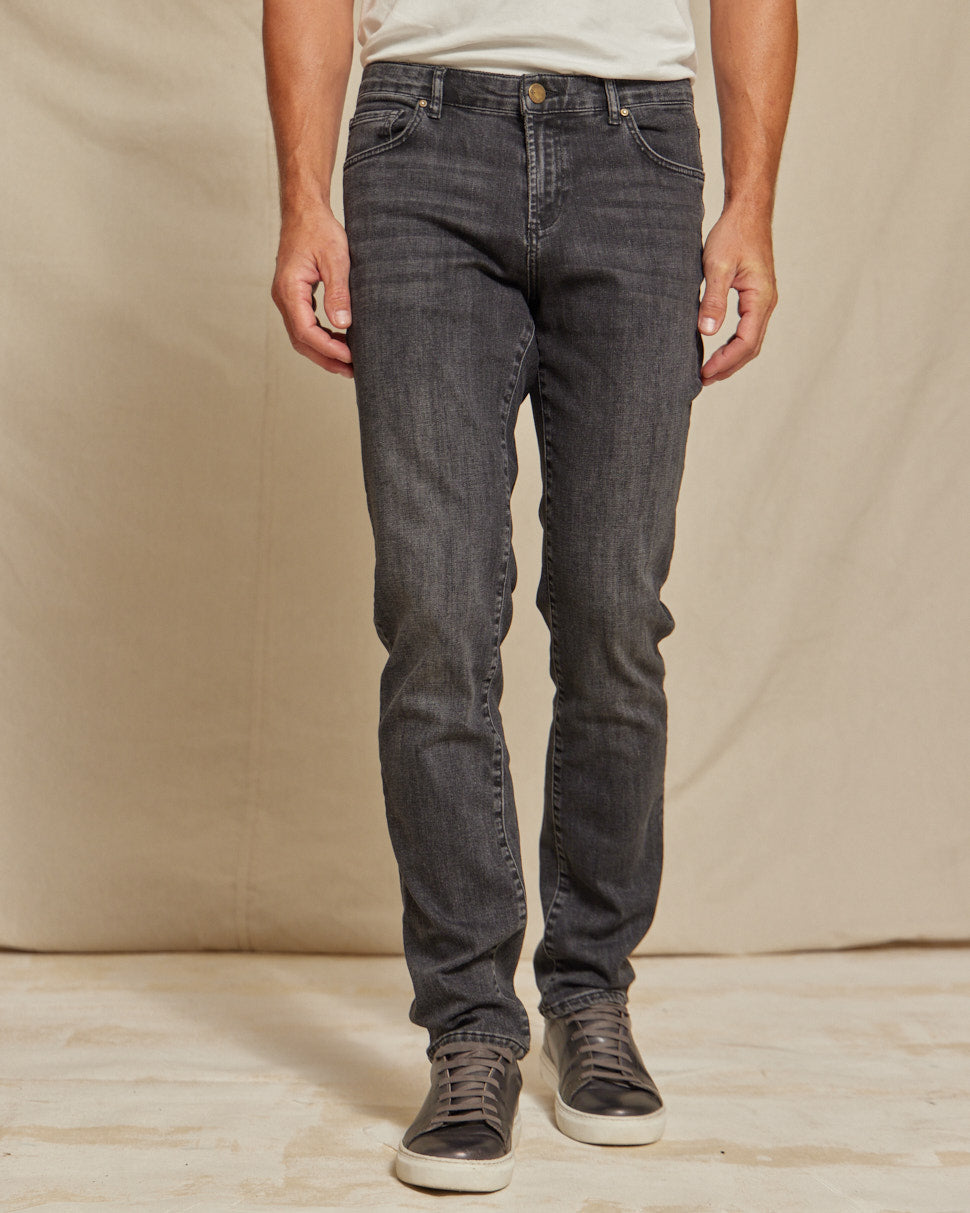 Men's stretch denim jeans by Olive & Evy featuring a durable, slim fit and 4-way performance stretch fabric.