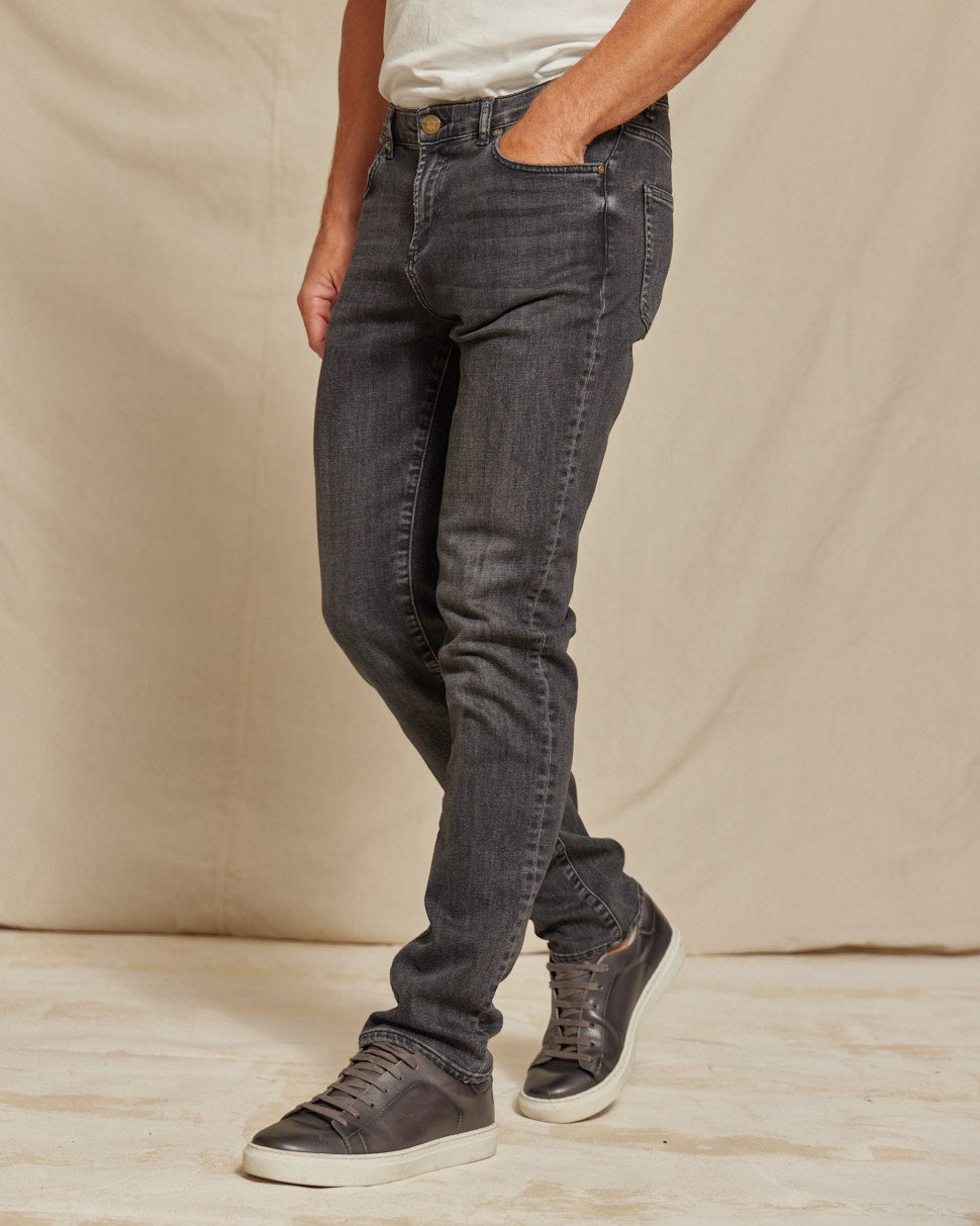 Men's stretch denim jeans by Olive & Evy featuring a durable fit and 4-way performance, shown in a classic blue wash.
