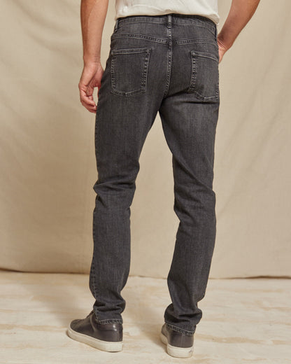 Men's stretch denim jeans by Olive & Evy featuring a durable fit and 4-way performance stretch, shown in a classic blue wash.