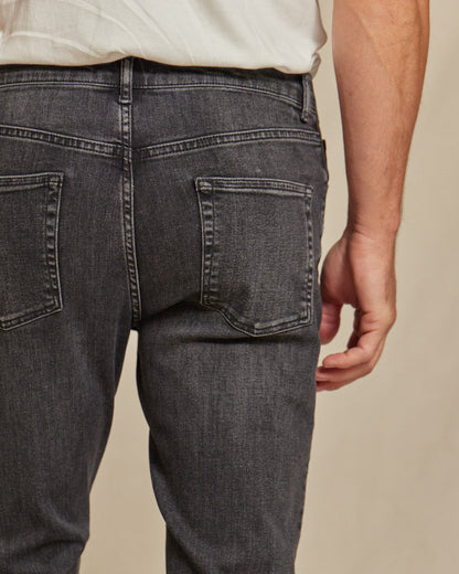 Men's stretch denim jeans by Olive & Evy with a durable fit and 4-way performance, shown in a classic blue color.