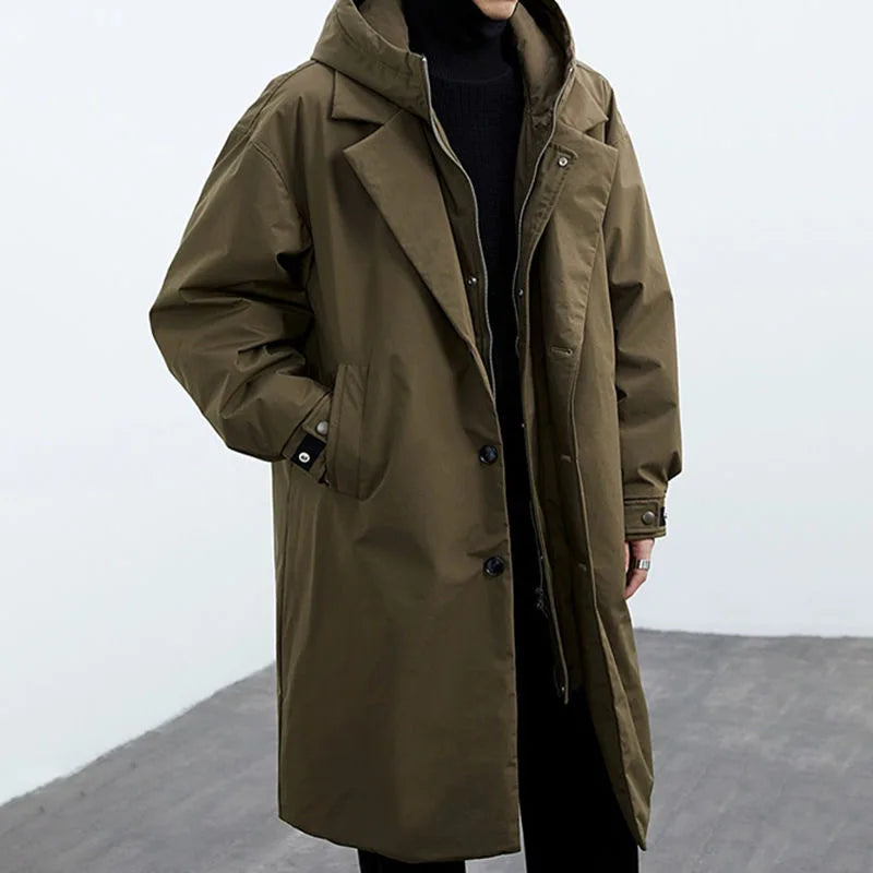 Light beige Darnell trench coat by Jack Hafford hanging on a hook, showcasing classic double-breasted design and wide lapels.