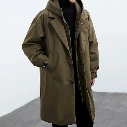 Light beige Darnell trench coat by Jack Hafford hanging on a hook, showcasing classic double-breasted design and wide lapels.