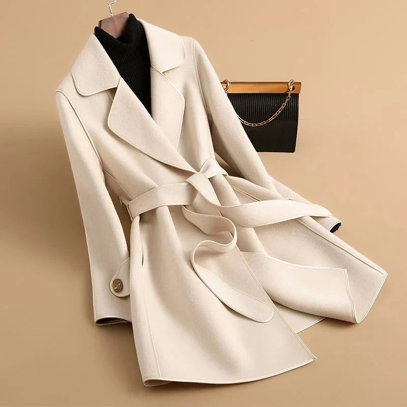 Jack Hafford Jennie trench coat in beige, shown on a model, featuring classic design and belted waist for a timeless look.