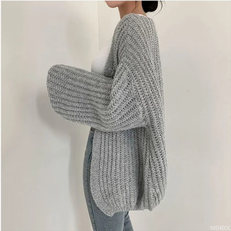 Homixa chunky-knit women's cardigan with a relaxed fit, featuring a cozy, textured knit pattern and front buttons.