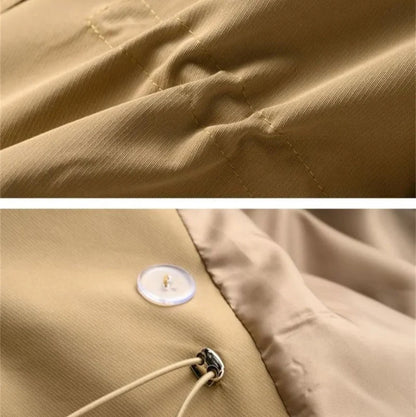 Sweet Emily trench coat by Jack Hafford hanging on a wooden hanger, showing its classic beige color and stylish design.