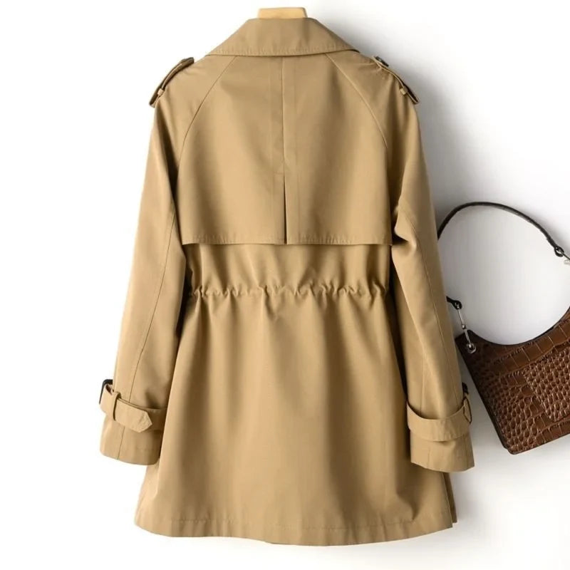 Sweet Emily trench coat by Jack Hafford, featuring classic design, beige color, and double-breasted buttons, styled with a belt.