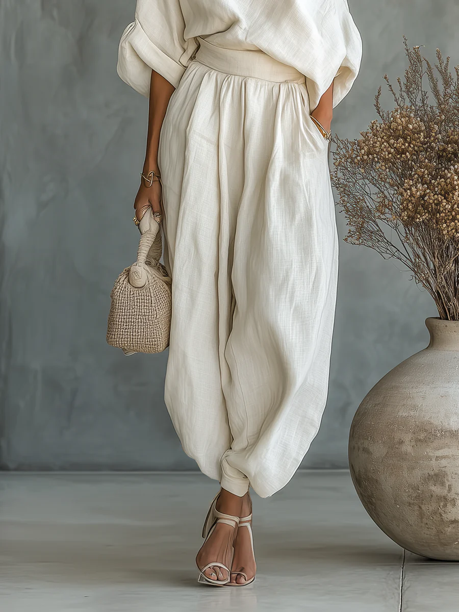 Off-white linen off-shoulder casual top and tapered pants set by gfhj, featuring relaxed fit and lightweight fabric.