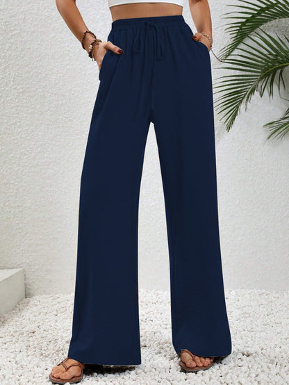 Dobrina wide-leg tailored trousers for women by Kate and Wendy, featuring a draped design and relaxed fit.