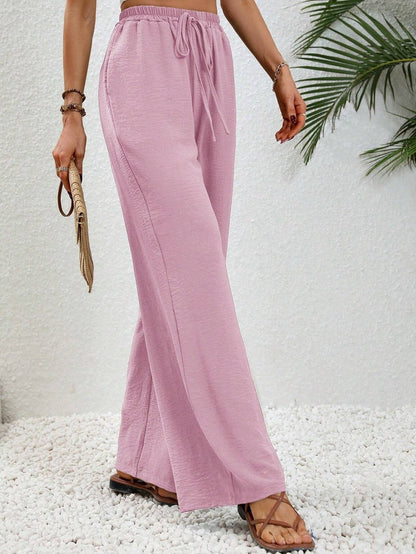 Dobrina wide-leg tailored women's trousers by Kate and Wendy, featuring a draped, flowing design and high waist.