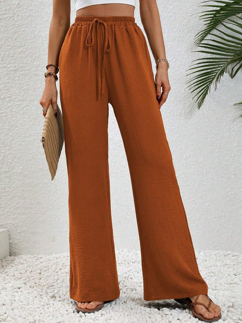 Dobrina wide-leg tailored trousers for women by Kate and Wendy, featuring a draped design and relaxed fit.