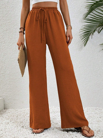Dobrina wide-leg tailored trousers for women by Kate and Wendy, featuring a draped design and relaxed fit.