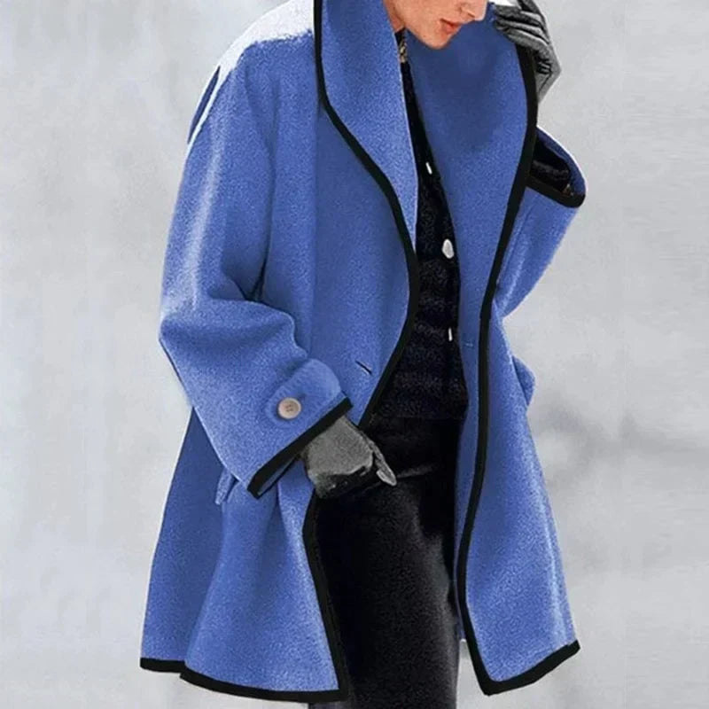 Homixa Agnes women's merino wool trench coat with statement collar, contrast trim, and buttoned cuffs, shown in blue.