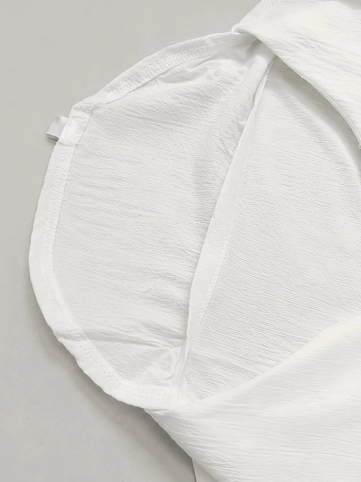 Men's solid color V-neck long sleeve Henley shirt by Homixa, shown in a close-up of the black shirt with buttons and soft fabric.