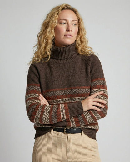 Close-up of Homixa Lily women's fair-isle turtleneck sweater with patterned sleeves and ribbed cuffs, showcasing cozy knit details.