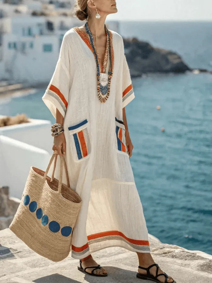 Women's Homixa Ekeesha maxi dress with contrast trim, V-neck, and front pocket, flowing sleeveless design.