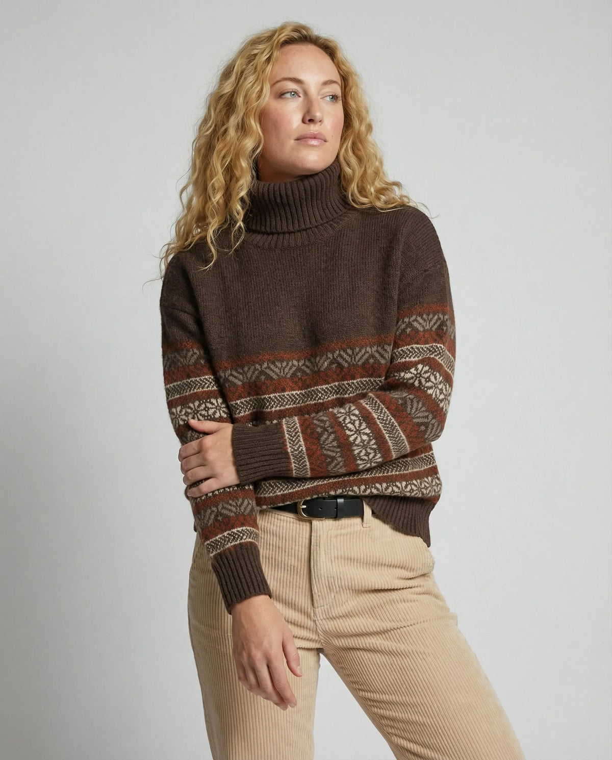 Homixa Lily women's fair-isle turtleneck sweater with patterned sleeves and ribbed cuffs, worn full-body from the front.