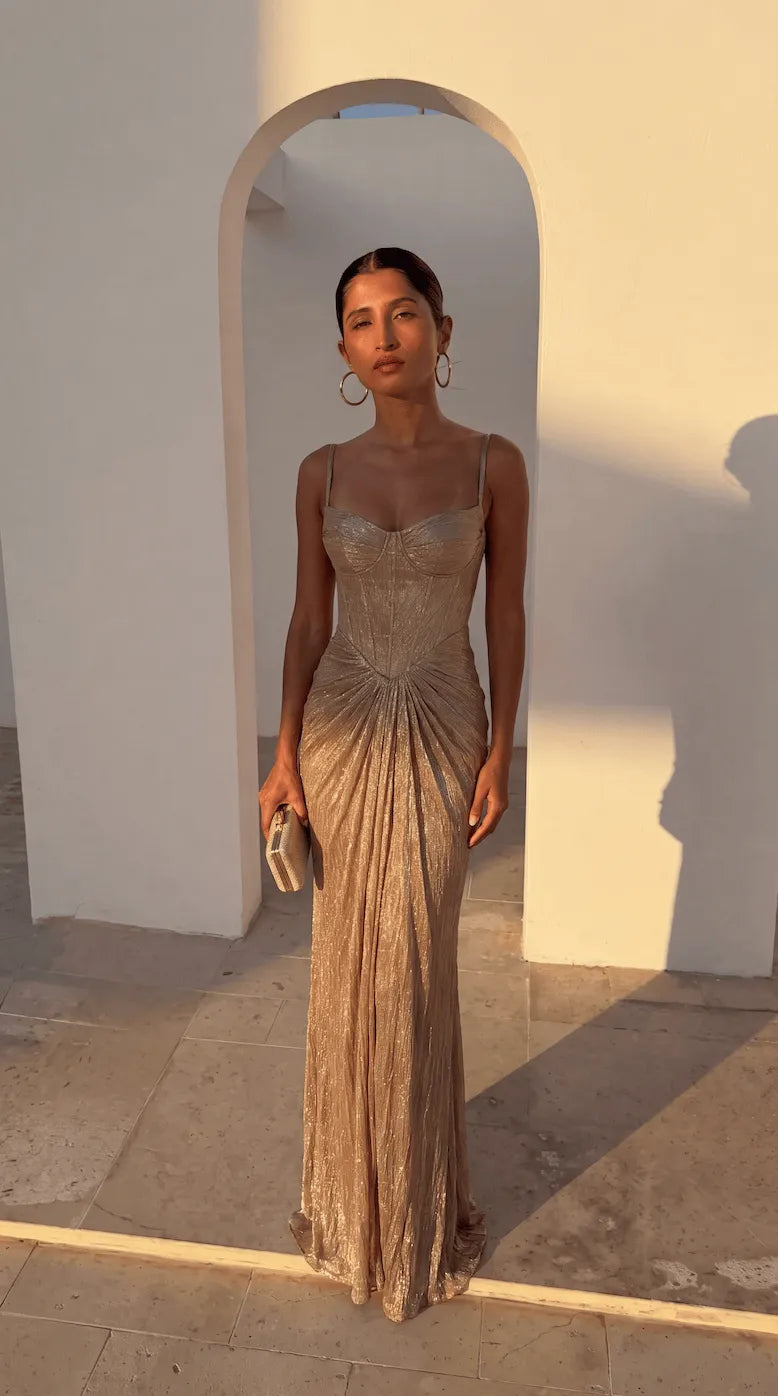 Elegant women's gold ruched corset maxi dress by Homixa, featuring a fitted bodice and flowing skirt for a sophisticated look.