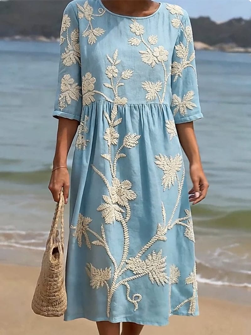 Homixa Flora women's embroidered maxi dress with intricate floral embroidery and flowing fabric on a model.